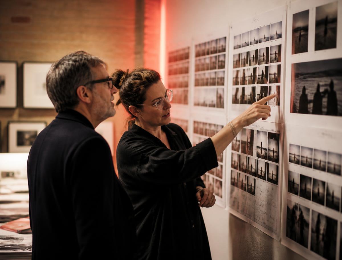 Studio directors reviewing printed image contact sheets